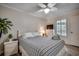 Comfortable bedroom with a ceiling fan, bedside table, and a bright window at 9400 Shore Dr. # 506, Myrtle Beach, SC 29572