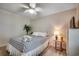 Cozy bedroom with a comfortable bed, palm tree decor, ceiling fan, and light wood flooring at 9400 Shore Dr. # 506, Myrtle Beach, SC 29572