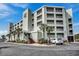 Attractive multi-story building with palm trees, balconies, and well-maintained landscaping at 9400 Shore Dr. # 506, Myrtle Beach, SC 29572