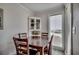 Cozy dining area with a dark wood table, a china cabinet, and natural light streaming through the window at 9400 Shore Dr. # 506, Myrtle Beach, SC 29572