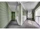 Exterior hallway featuring white railings, green siding, and a front door at 9400 Shore Dr. # 506, Myrtle Beach, SC 29572
