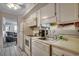 Functional kitchen features white appliances and cabinetry with an opening to living area at 9400 Shore Dr. # 506, Myrtle Beach, SC 29572