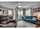 Comfortable living room with seating, view of patio, lots of light, and wood grain flooring at 9400 Shore Dr. # 506, Myrtle Beach, SC 29572