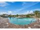Community outdoor pool with lounge chairs and lush tropical landscaping at 9400 Shore Dr. # 506, Myrtle Beach, SC 29572