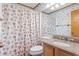 Bathroom featuring seashell wallpaper, vanity with mirror, and tub-shower combo at 9540 Shore Dr. # 3-H, Myrtle Beach, SC 29572