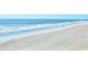 Expansive beach view with gentle waves meeting the sandy shore at 9540 Shore Dr. # 3-H, Myrtle Beach, SC 29572