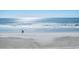 Serene beach scene with gentle waves and a couple walking along the shore at 9540 Shore Dr. # 3-H, Myrtle Beach, SC 29572