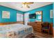 Comfortable bedroom featuring wood paneling, ceiling fan, and sliding glass doors at 9540 Shore Dr. # 3-H, Myrtle Beach, SC 29572