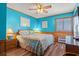 Cozy bedroom featuring turquoise walls, wood trim, and ceiling fan at 9540 Shore Dr. # 3-H, Myrtle Beach, SC 29572