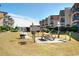 Community grilling area with picnic table and green space in front of condo buildings at 9540 Shore Dr. # 3-H, Myrtle Beach, SC 29572