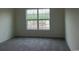 This room features gray carpet floors and a large window at 1411 Gooseneck Place # 202 Middle, Murrells Inlet, SC 29576