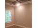 Empty bedroom with tray ceiling, neutral paint, and large window at 1411 Gooseneck Place # 202 Middle, Murrells Inlet, SC 29576
