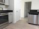 Modern kitchen equipped with stainless steel appliances, granite countertops, and convenient access to the bathroom at 1411 Gooseneck Place # 202 Middle, Murrells Inlet, SC 29576