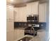 Updated kitchen with stainless steel appliances, granite countertops, and mosaic tile backsplash at 1411 Gooseneck Place # 202 Middle, Murrells Inlet, SC 29576