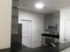 Well lit kitchen features gray cabinets, black counters, and stainless steel appliances at 1411 Gooseneck Place # 202 Middle, Murrells Inlet, SC 29576