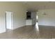 Bright and airy living room featuring hardwood floors, chandelier, and an open layout that flows into the kitchen at 1411 Gooseneck Place # 202 Middle, Murrells Inlet, SC 29576