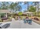 Beautiful backyard patio with lounge chairs, umbrella, and adjacent putting green at 152 Creek Harbour Circle, Murrells Inlet, SC 29576
