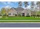Beautifully landscaped, single story, brick home with a well manicured lawn and mature landscaping at 152 Creek Harbour Circle, Murrells Inlet, SC 29576