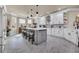 Spacious kitchen with white cabinets, stainless steel appliances, grey island, and stone tile floors at 152 Creek Harbour Circle, Murrells Inlet, SC 29576
