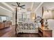 Elegant main bedroom featuring a tray ceiling, hardwood floors, and large windows at 152 Creek Harbour Circle, Murrells Inlet, SC 29576