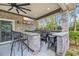 Outdoor kitchen with bar seating, granite countertops, grill, and tv at 152 Creek Harbour Circle, Murrells Inlet, SC 29576