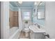 Bathroom with shower-tub combo, neutral tile, white vanity, and mirror at 202 56Th Ave. N, North Myrtle Beach, SC 29582