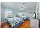 Bedroom with two beds, ceiling fan, wood floors and blue, beach-themed decor at 202 56Th Ave. N, North Myrtle Beach, SC 29582