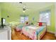 Bright bedroom with two beds, hardwood floors, ceiling fan, and plenty of natural light at 202 56Th Ave. N, North Myrtle Beach, SC 29582