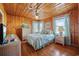 A wood-paneled bedroom with a queen bed, hardwood floors, two windows, and bright decor at 202 56Th Ave. N, North Myrtle Beach, SC 29582