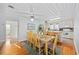Dining room area is adjacent to the kitchen, with a large dining table and hardwood floors at 202 56Th Ave. N, North Myrtle Beach, SC 29582