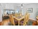 Living and dining room boasts a ceiling fan, wood floors, and comfortable furnishings at 202 56Th Ave. N, North Myrtle Beach, SC 29582