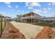 Elevated beach home featuring a spacious driveway and a well-manicured lawn at 202 56Th Ave. N, North Myrtle Beach, SC 29582