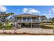 Two-story beach house with a large deck and covered parking underneath the house, inviting coastal charm at 202 56Th Ave. N, North Myrtle Beach, SC 29582