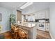 Cozy kitchen featuring white cabinets, granite countertops, and an island with barstool seating at 202 56Th Ave. N, North Myrtle Beach, SC 29582