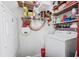 Organized laundry room with shelving for storage above white washer and dryer machines at 202 56Th Ave. N, North Myrtle Beach, SC 29582