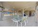 Spacious outdoor area under an elevated home, featuring a dining set and stairway at 202 56Th Ave. N, North Myrtle Beach, SC 29582