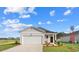 Charming one-story home with a single-car garage and beautifully landscaped front yard at 227 Warner Crossing Way, Loris, SC 29569