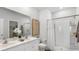 Bright bathroom featuring a double vanity sink and a large walk-in shower at 235 Warner Crossing Way, Loris, SC 29569