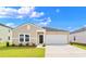 Inviting single-story home with a manicured lawn and attached two-car garage at 235 Warner Crossing Way, Loris, SC 29569