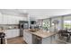 Open concept kitchen with stainless steel appliances and island open to the dining and living spaces at 235 Warner Crossing Way, Loris, SC 29569