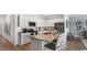 Modern kitchen with white cabinets, stainless steel appliances and an island with seating at 235 Warner Crossing Way, Loris, SC 29569