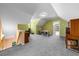 Finished attic with neutral carpeting, natural light, and bonus storage room at 270 Moulton Dr., Longs, SC 29568