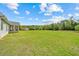 Expansive lush backyard with a storage shed, view of the pond, and mature trees at 270 Moulton Dr., Longs, SC 29568