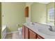 Bathroom featuring double sinks, a large mirror, and a separate tub at 270 Moulton Dr., Longs, SC 29568