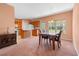 Open dining area featuring a chandelier, a marble table, a kitchen, and carpet floors at 270 Moulton Dr., Longs, SC 29568