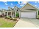 Inviting single Gathering home showcasing attractive landscaping, manicured lawn, and a spacious two-car garage at 270 Moulton Dr., Longs, SC 29568