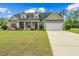 Charming single Gathering home with a well-maintained front yard, long driveway and 2-car garage at 270 Moulton Dr., Longs, SC 29568