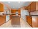Well-lit kitchen featuring an island, tile flooring, and wooden cabinetry at 270 Moulton Dr., Longs, SC 29568