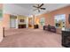 Bright and airy living room featuring large windows, a ceiling fan, and staircase leading to the upper level at 270 Moulton Dr., Longs, SC 29568