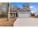 Charming single-Gathering home boasts a three-car garage, manicured lawn, and sidewalk at 334 William Nobles Rd., Aynor, SC 29511